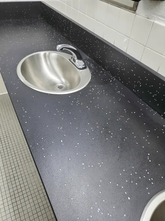 Spotless restroom countertop and sink after detailed sanitizing service