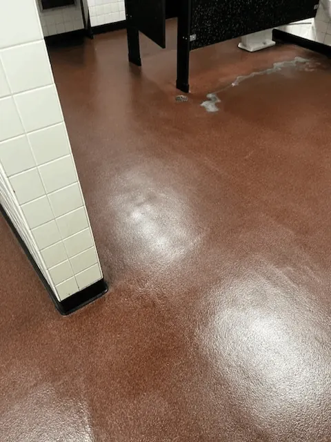 Polished commercial restroom floor with mirror-like shine after deep cleaning